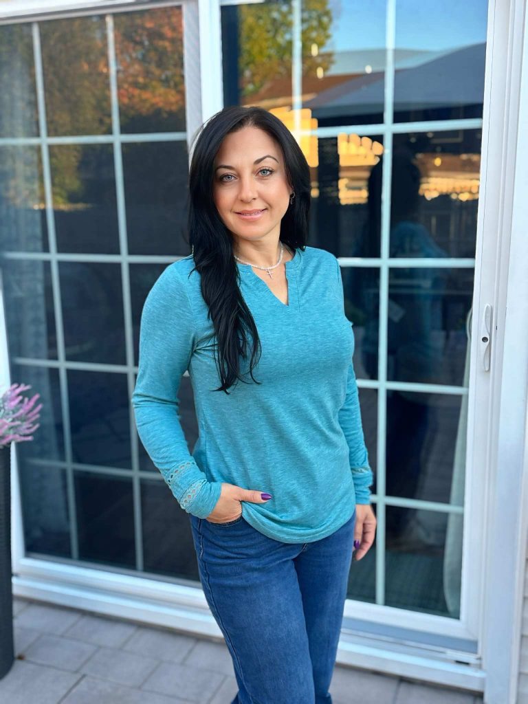 V-neck long sleeve tee with an eye-catching lace sleeve detail!
